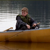 Man and boys trolling in a canoe